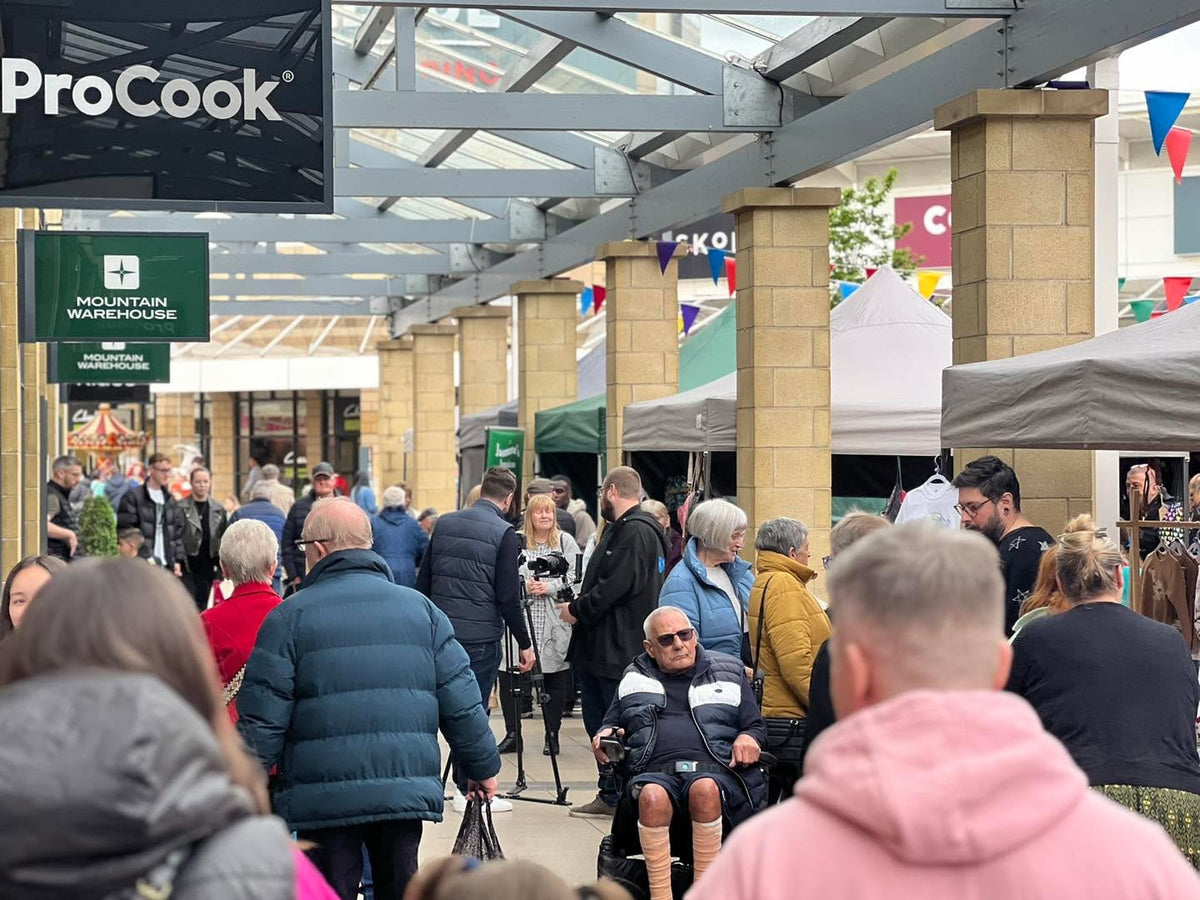 Busy market walkway and gazebo stalls near ProCook at Lakeside Village